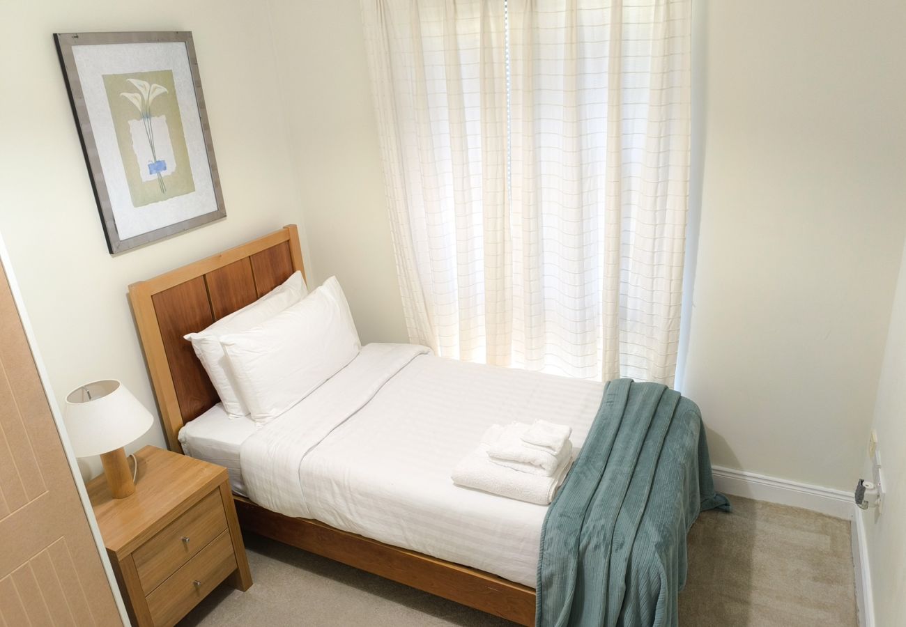 Heyward Mews Holiday Homes. Single bed. Compact room with large window. Modern stylish design.