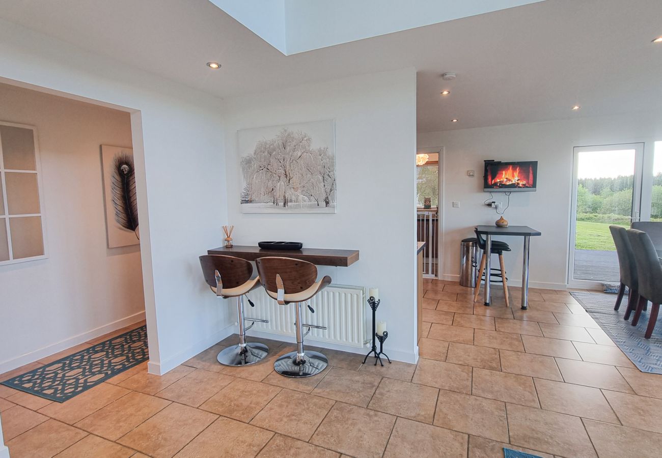 Riverrun Holiday Home No 15. Open plan kitchen dining area, seating at counter with views to lounge.