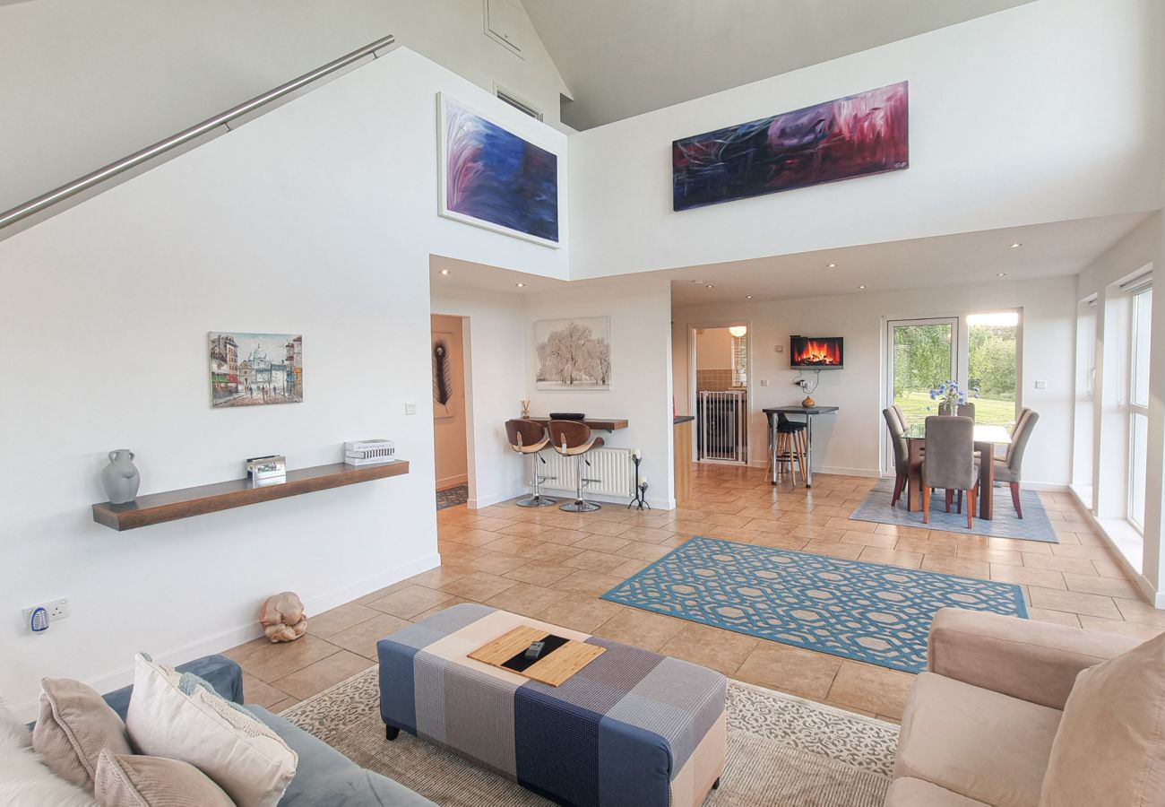 Riverrun Holiday Home No 15. Open plan bright, contemporary furnishing and art. Lounge with views to garden and Mezzanine. 