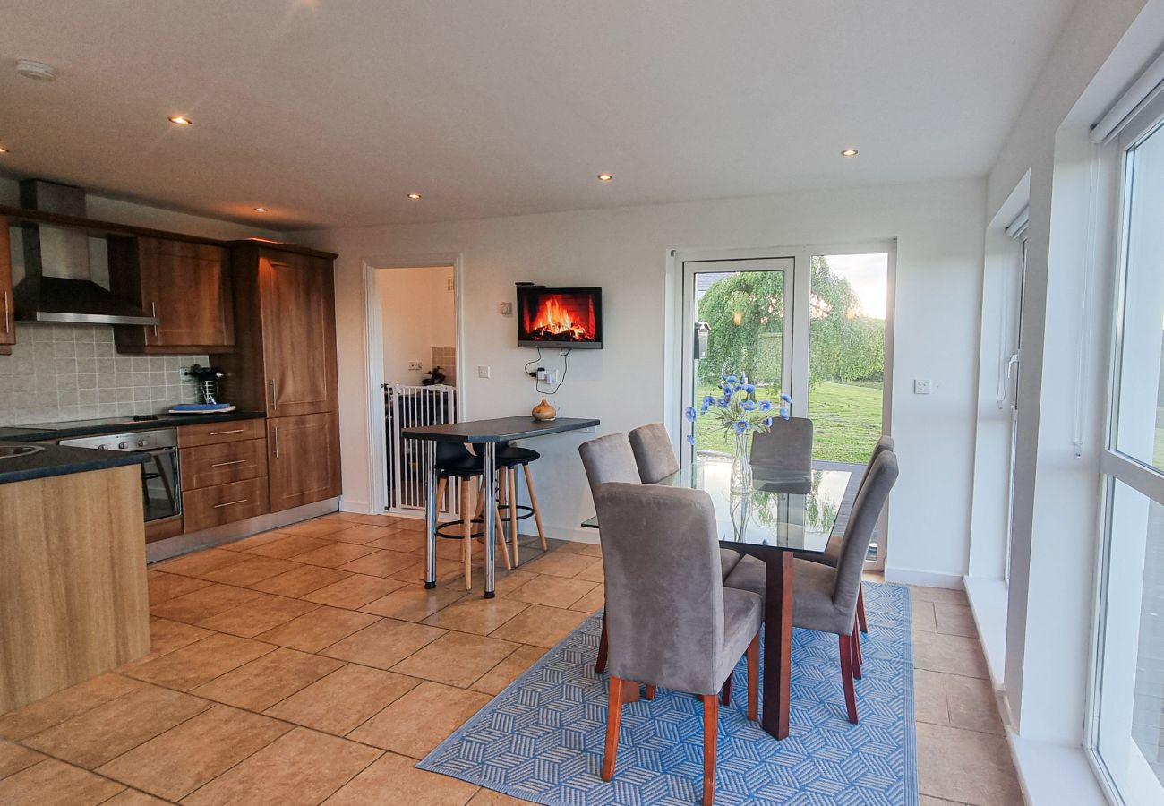 Riverrun Holiday Home No 15. Open plan kitchen dining area with views to garden from large window. 