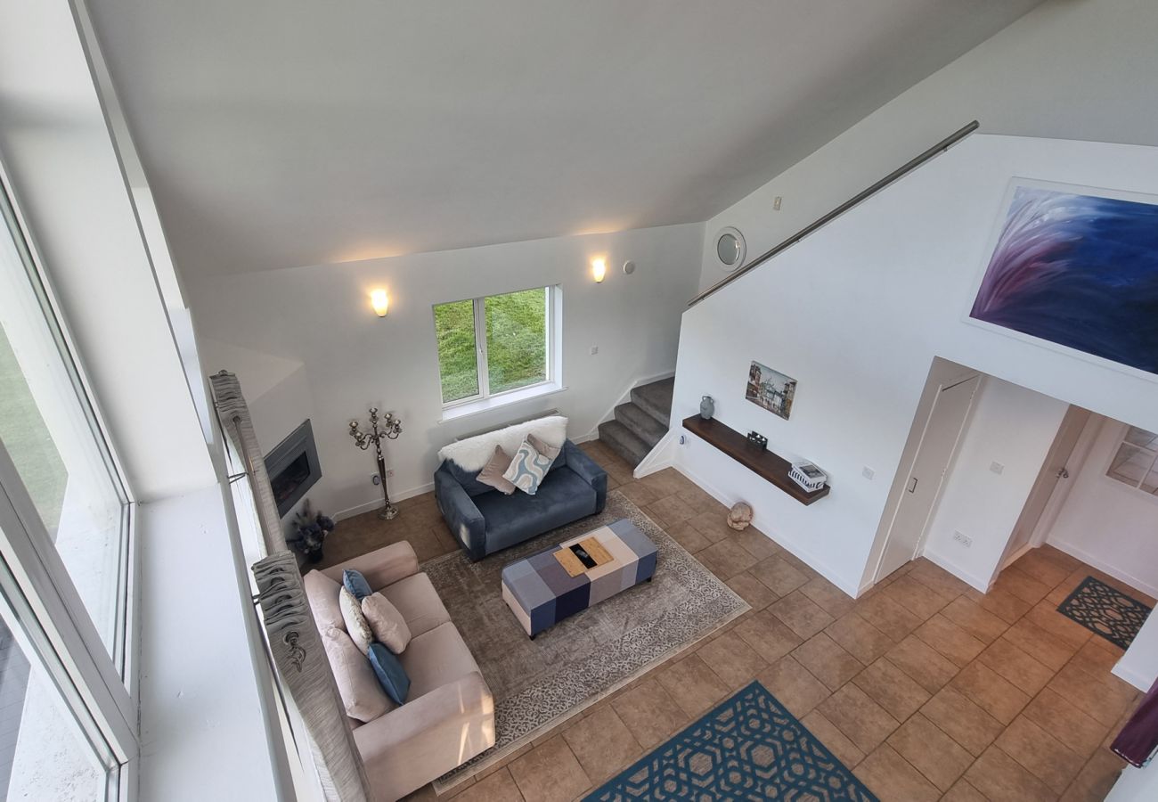 Riverrun Holiday Home No 15. Open plan view of living room from mezzanine level.