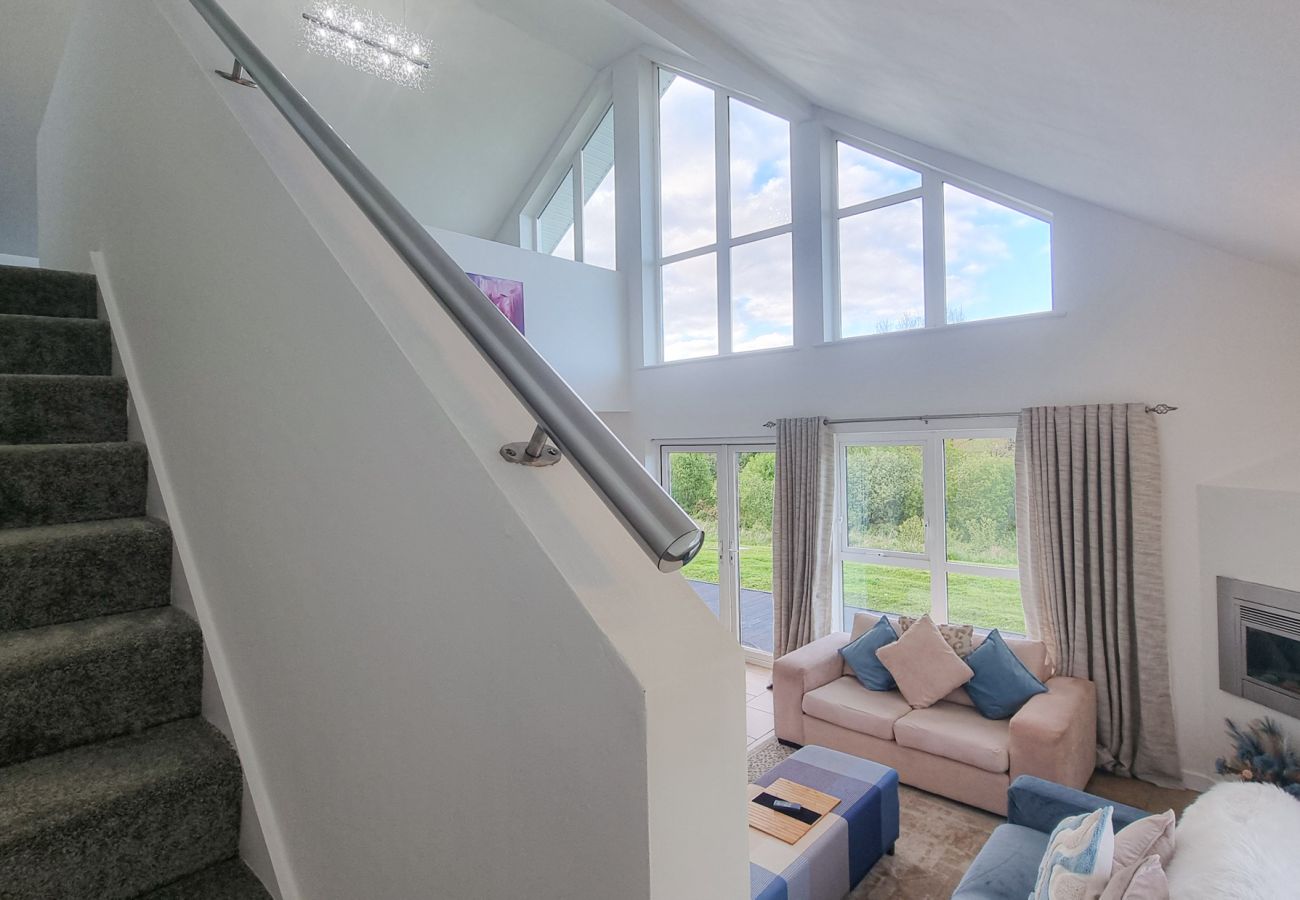 Riverrun Holiday Home No 15. Large windows with great light.  Open staircase to mezzanine. 