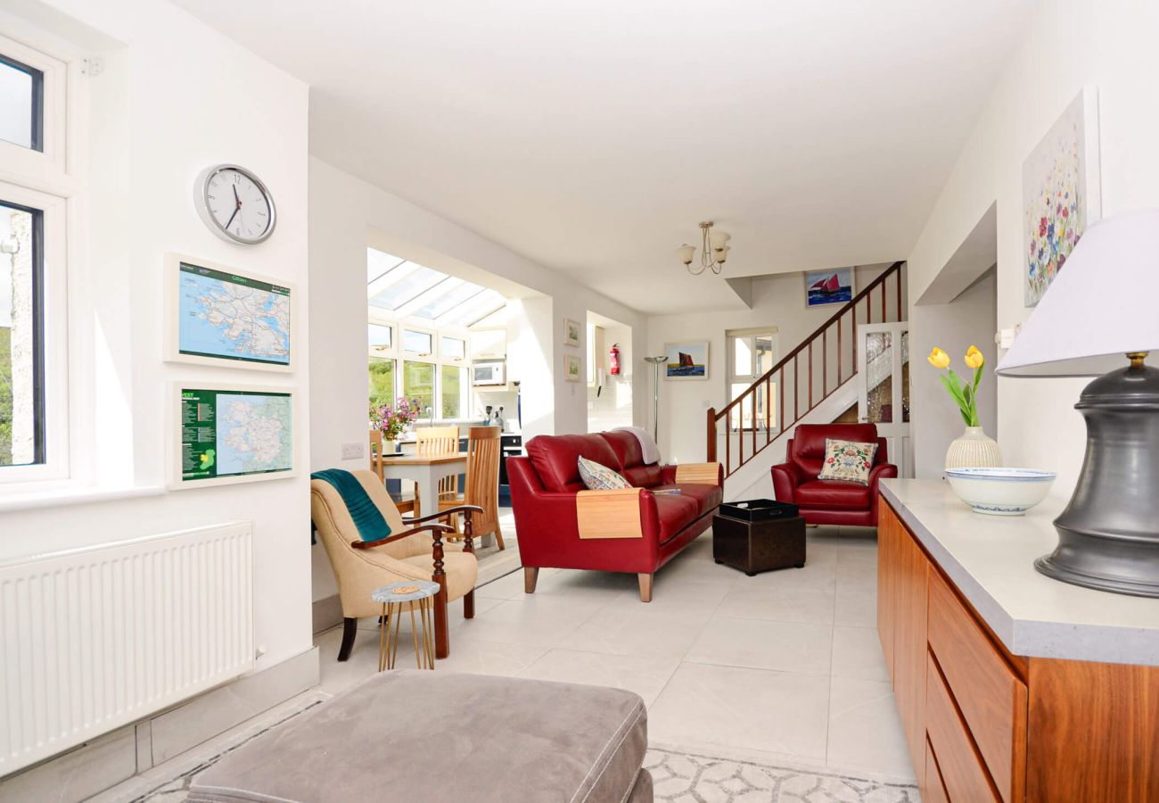 Bright living room with red sofas at Clifden Glen Holiday Village No.57 in Clifden, Co. Galway