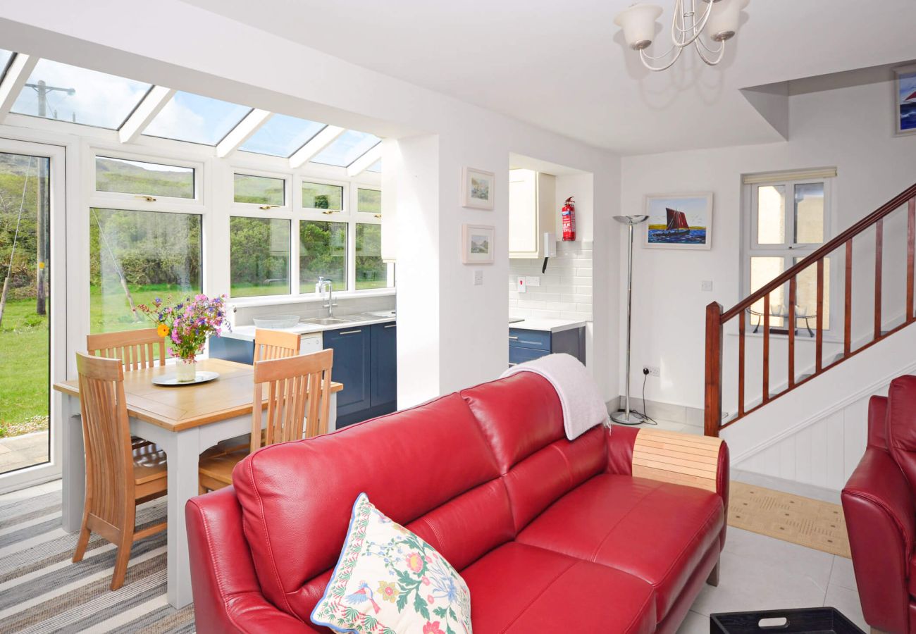 Living room area with red leather sofas at Clifden Glen Holiday Village No.57 in Clifden, Co. Galway