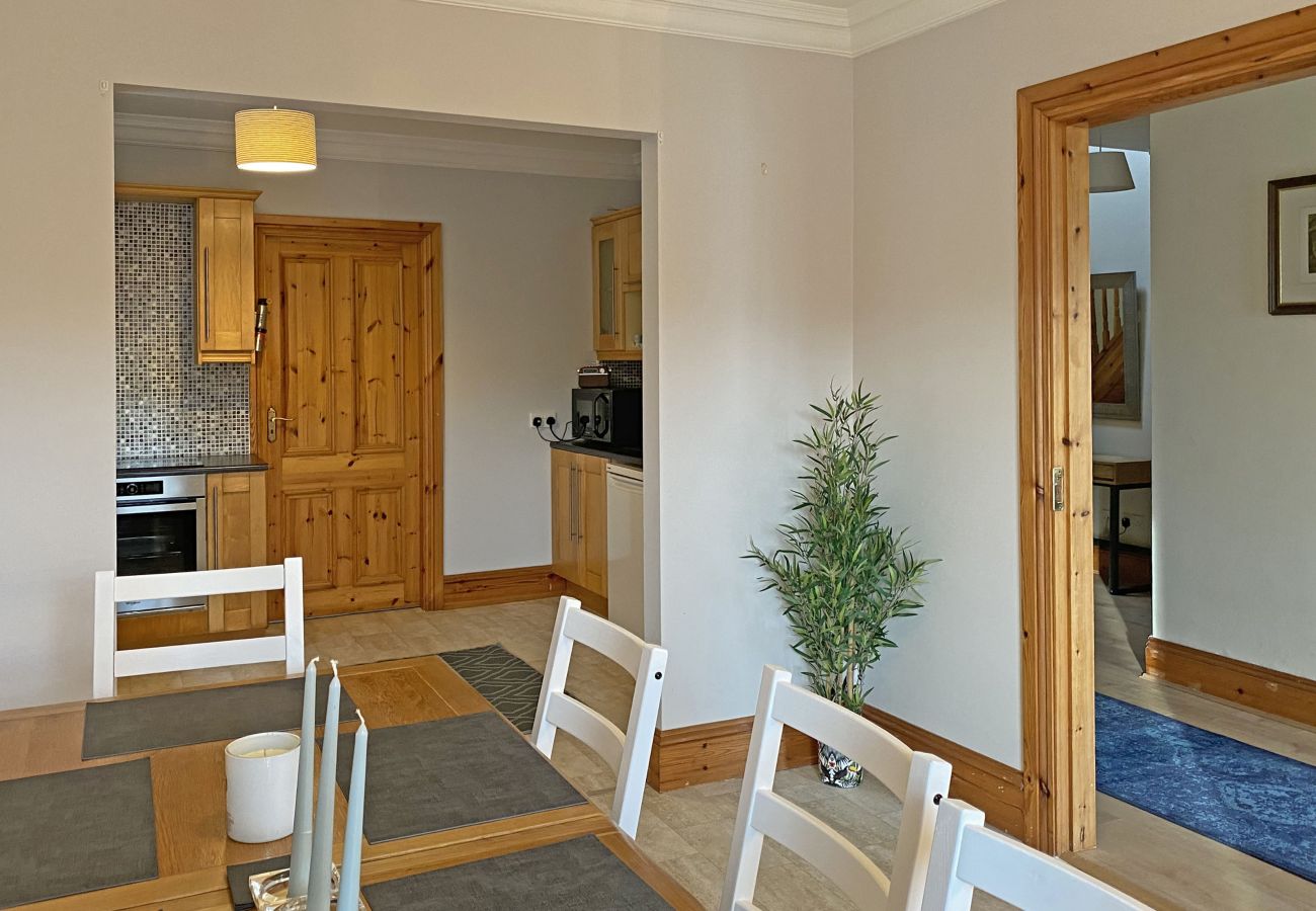 Open plan dining room and kitchen in Owenglin River Holiday Home