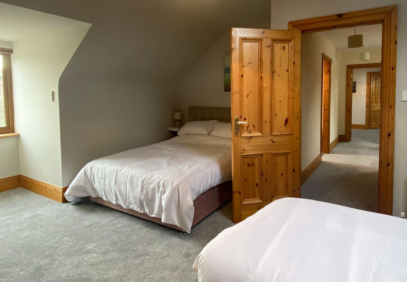 Bedroom and hall in Owenglin River Holiday Home in Galway