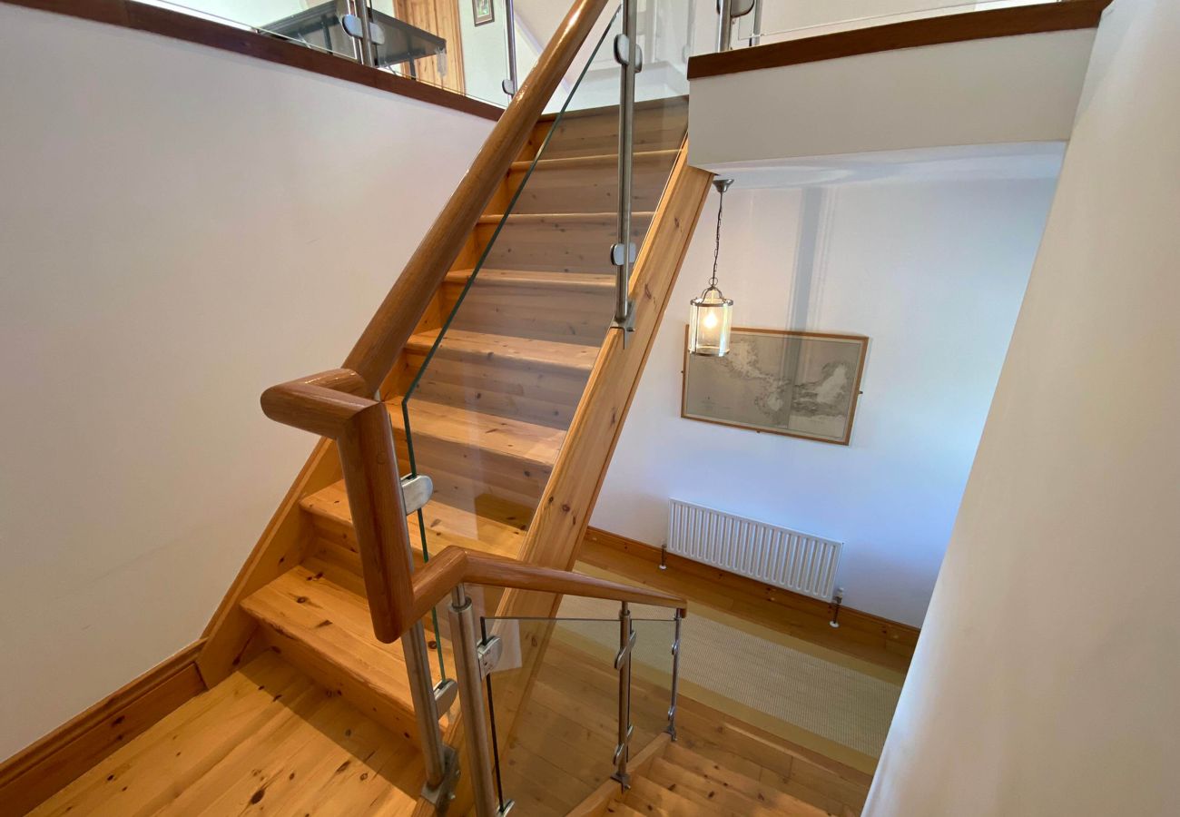 Wooden and glass stairs at Lough Corrib Luxury Holiday Home in Oughterard