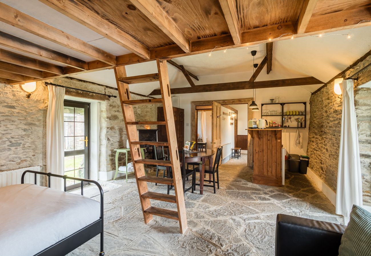 Shot from the master bedroom of dining  area , stairs and kitchenette Rainbow Cottage