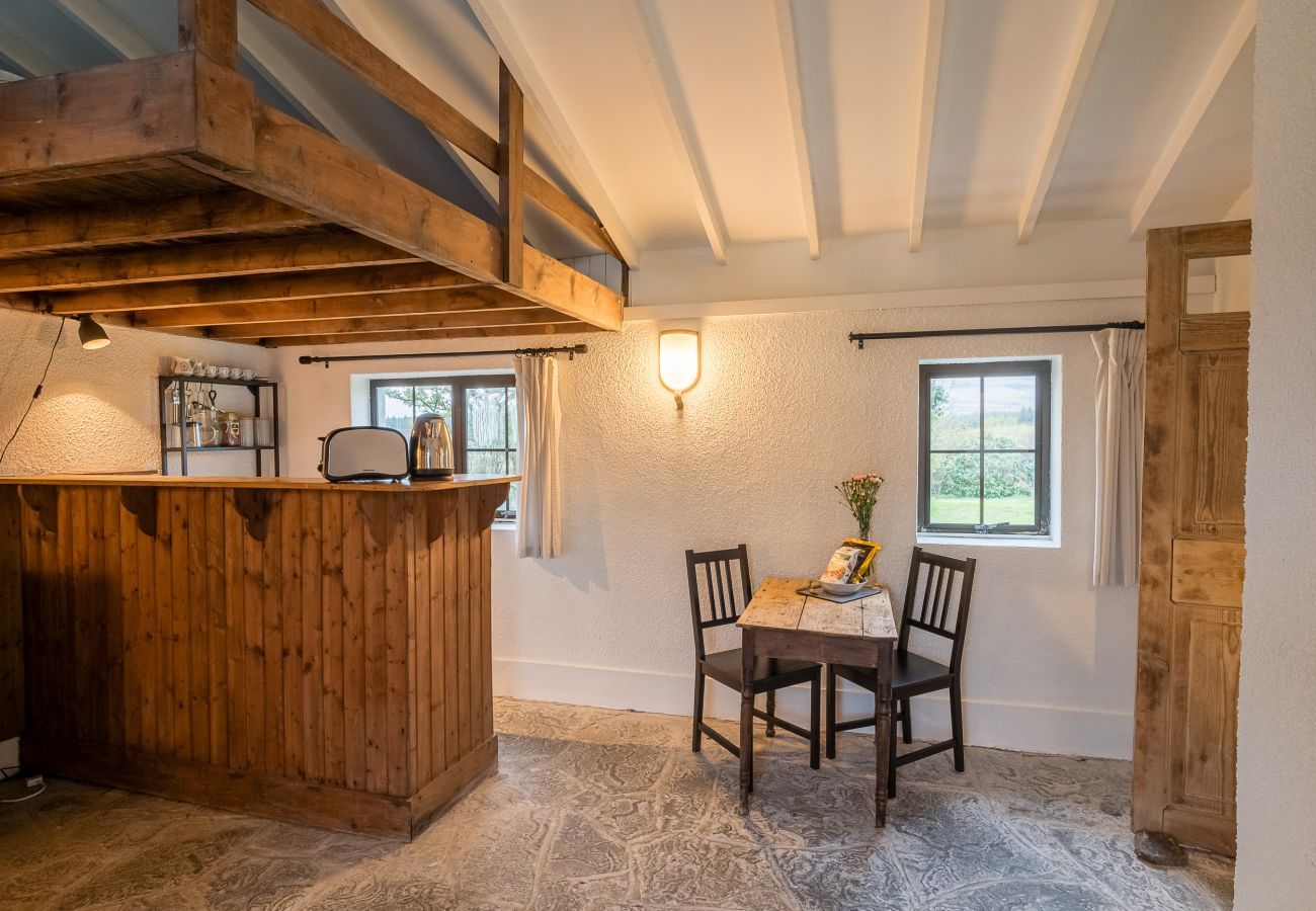 Dining table and kitchen area Ventry Farm Parlour Cottage