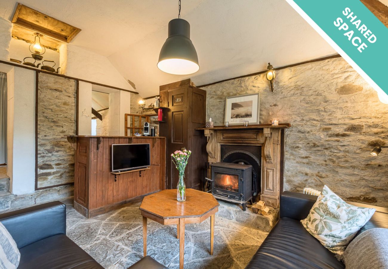 Shared Space Living Room with stove and television  Seaside Cottage