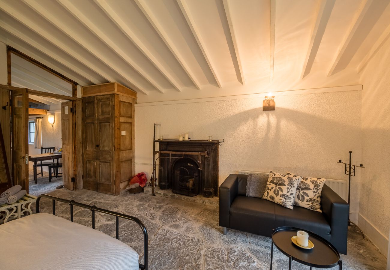 Seating area with open fire in Master Bedroom Ventry Farm Cottages 