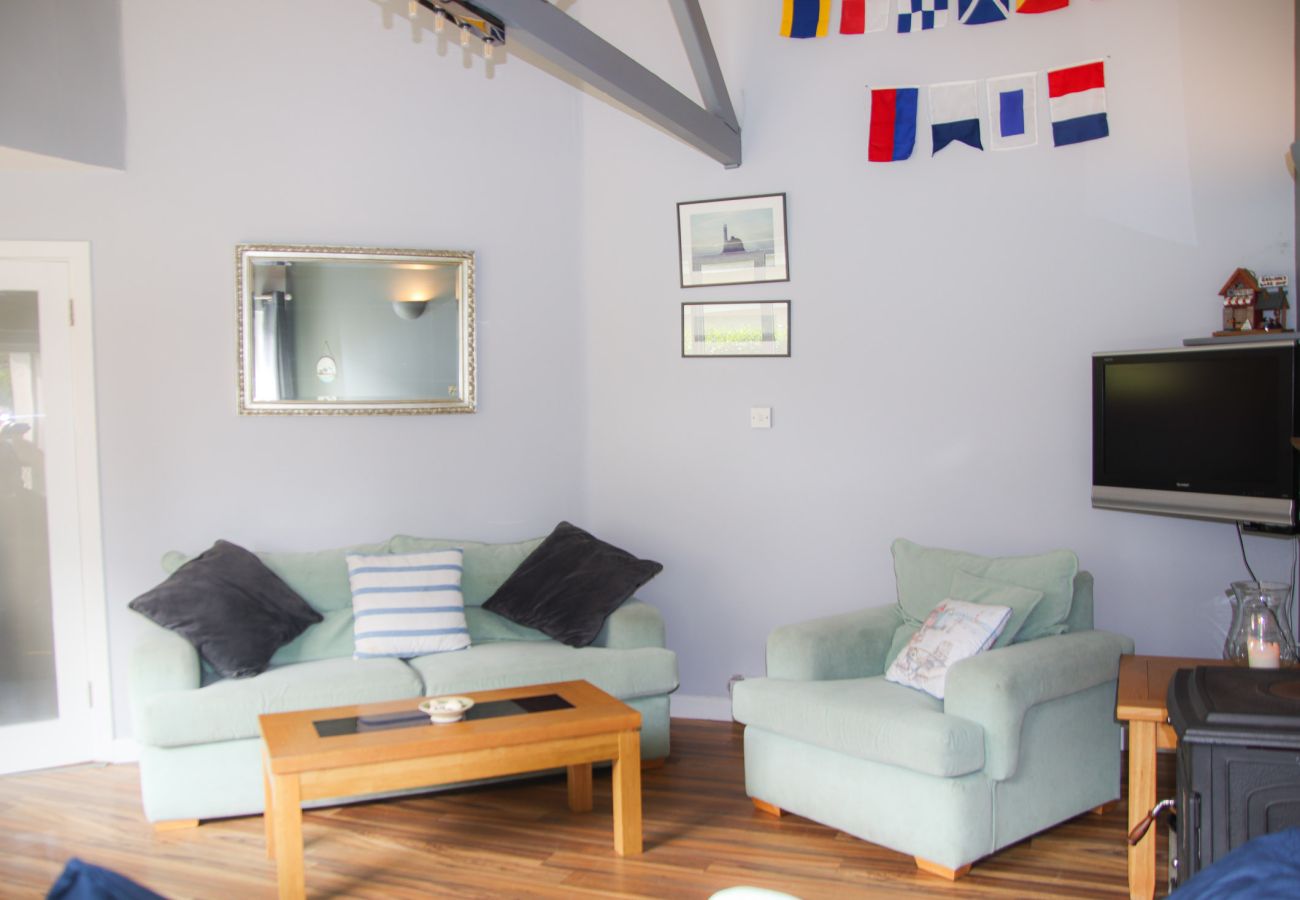 Lounge area in Dunmore Villas Holiday Home No 1 - holiday home. Contemporary interior wooden floors, soft furnishing.