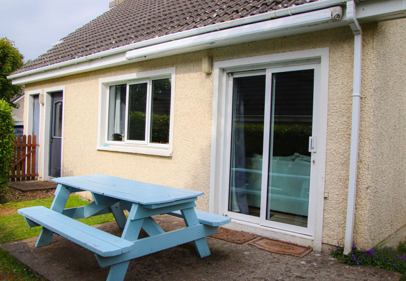 Outside dining area patio with access to kitchen at Dunmore Villas Holiday Home No 1 - well maintained garden at seaside family-friendly holiday home 