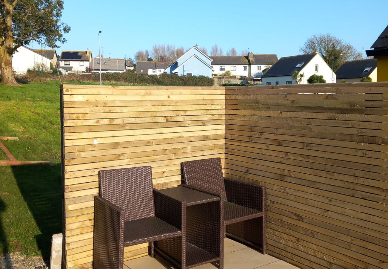 Sunny private seating area on patio. Green play area. Wooden fence, new refurbished patio. Seamount Holiday Village No.26. Seaside Holiday Home Availa