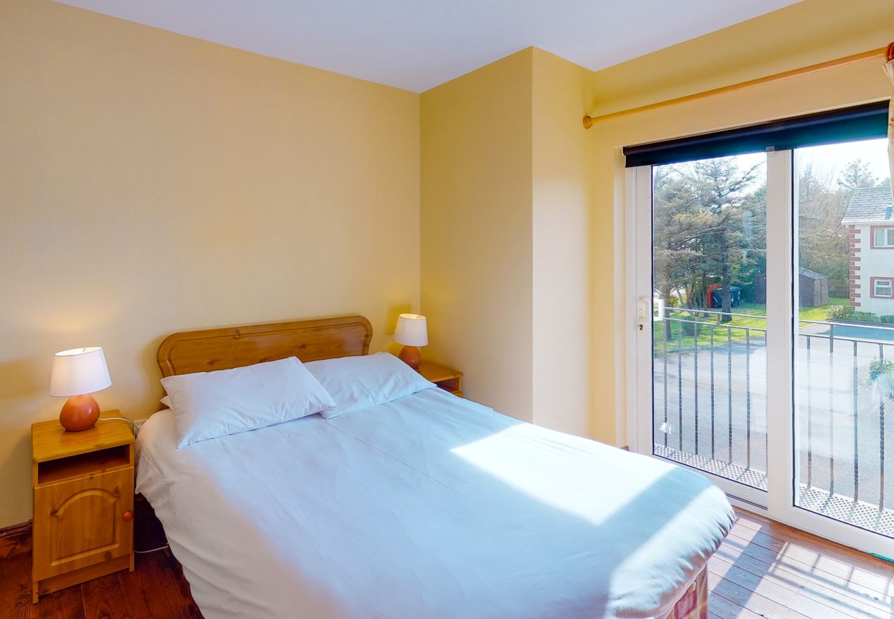 Seacliff Holiday Home No 12. Dunmore East, County Waterford, Ireland. Double bed, patio doors, patio. Bright.