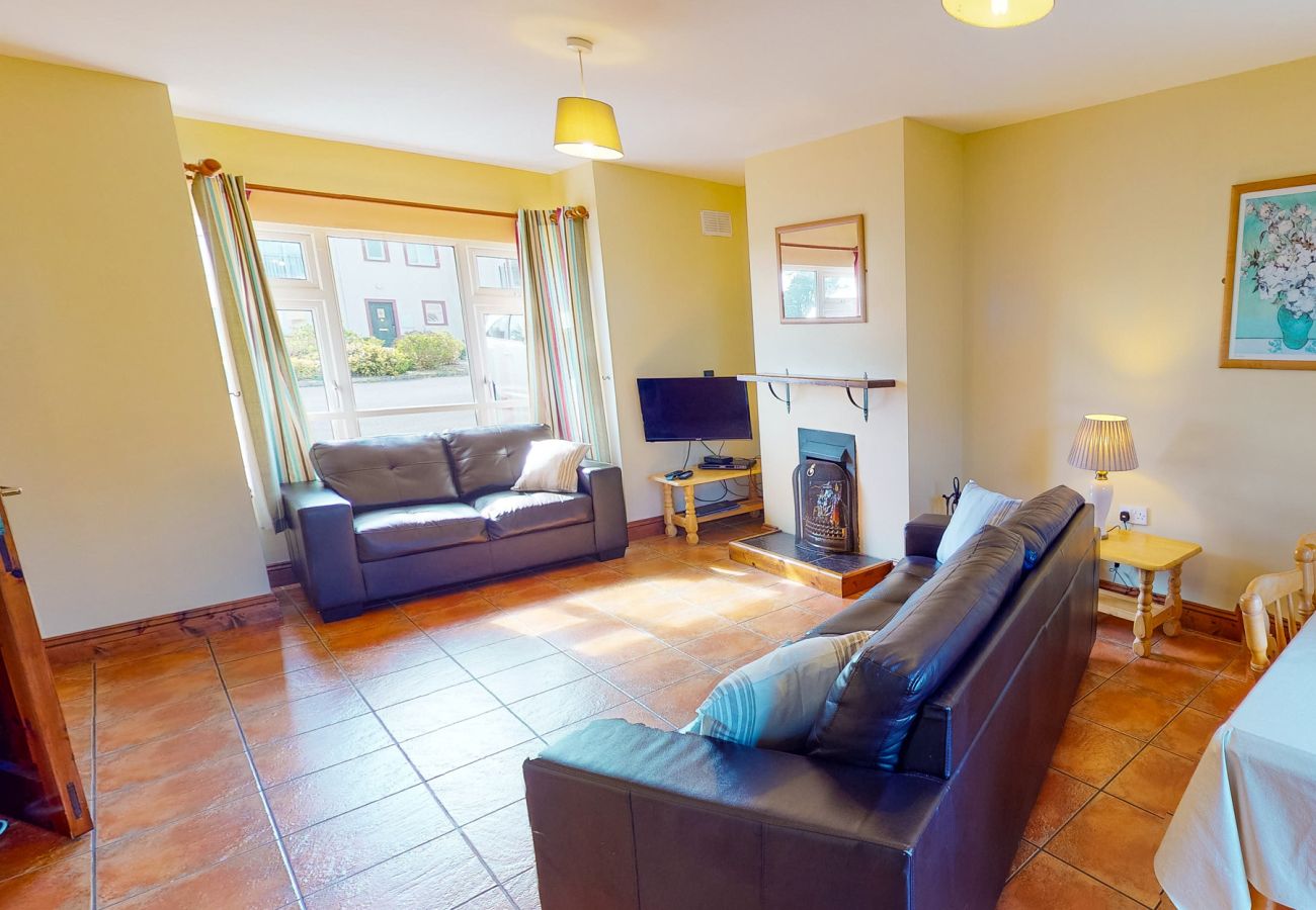 Dunmore East, County Waterford, Ireland. Dining table, open plan living room. Open Fire.