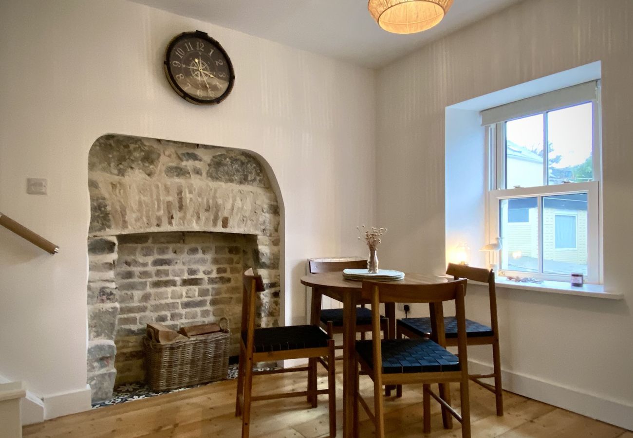 Clifden Town Townhouse. Connemara. Dining table seats 4. View to street. Open fire brick effect.