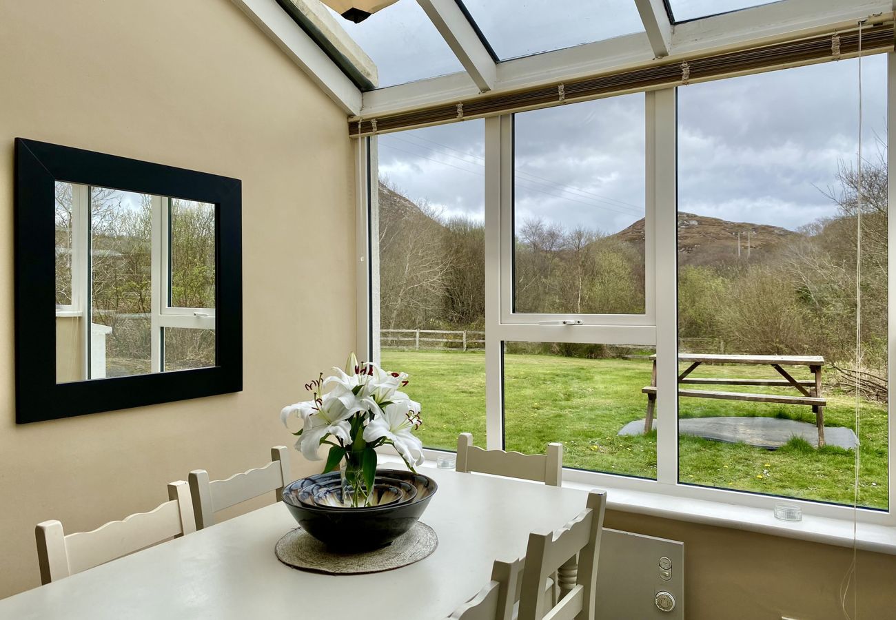 Clifden Glen Holiday Village No 30. Conservatory/Dining table with views.