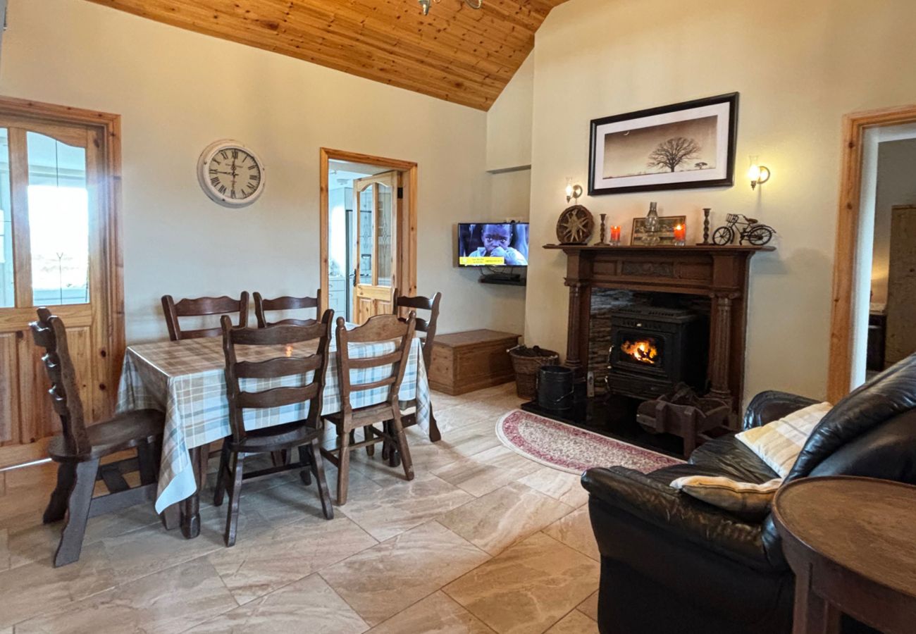 Conroy's Cottage Carna. Traditional open fire. Cosy living room, sofa wooden mezzanine. 