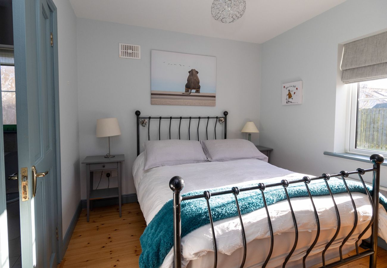 Brittas Bay Holiday Park No 7. Compact double room, wrought iron bed, bright cottage style. 