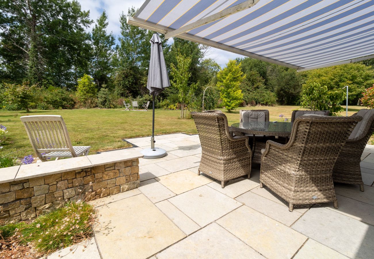 Brittas Bay Holiday Park No. 7. Paved patio in private garden. Awning and wicker garden furniture in mature garden. 