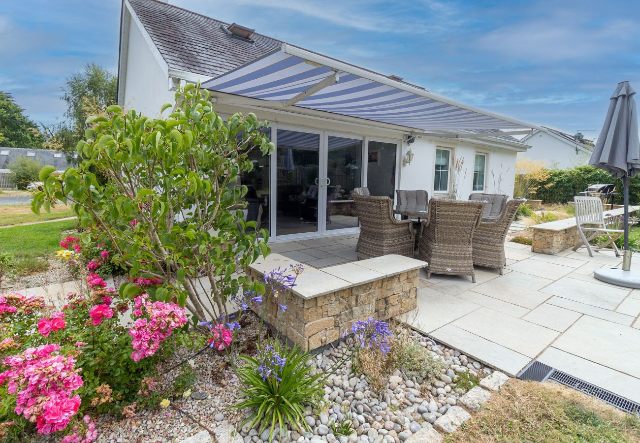 Brittas Bay Holiday Park No. 7. Exterior with patio, manicured garden, wicker furniture plus awning. 
