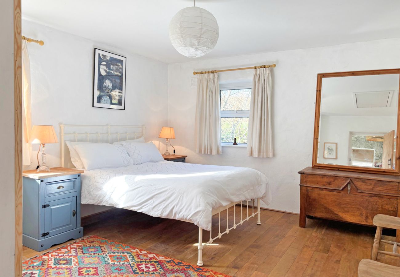 Moyard Stone Cottage, Connemara.  Double bedroom.  Wooden floors, cast iron bed, cottage style bright tasteful design. 