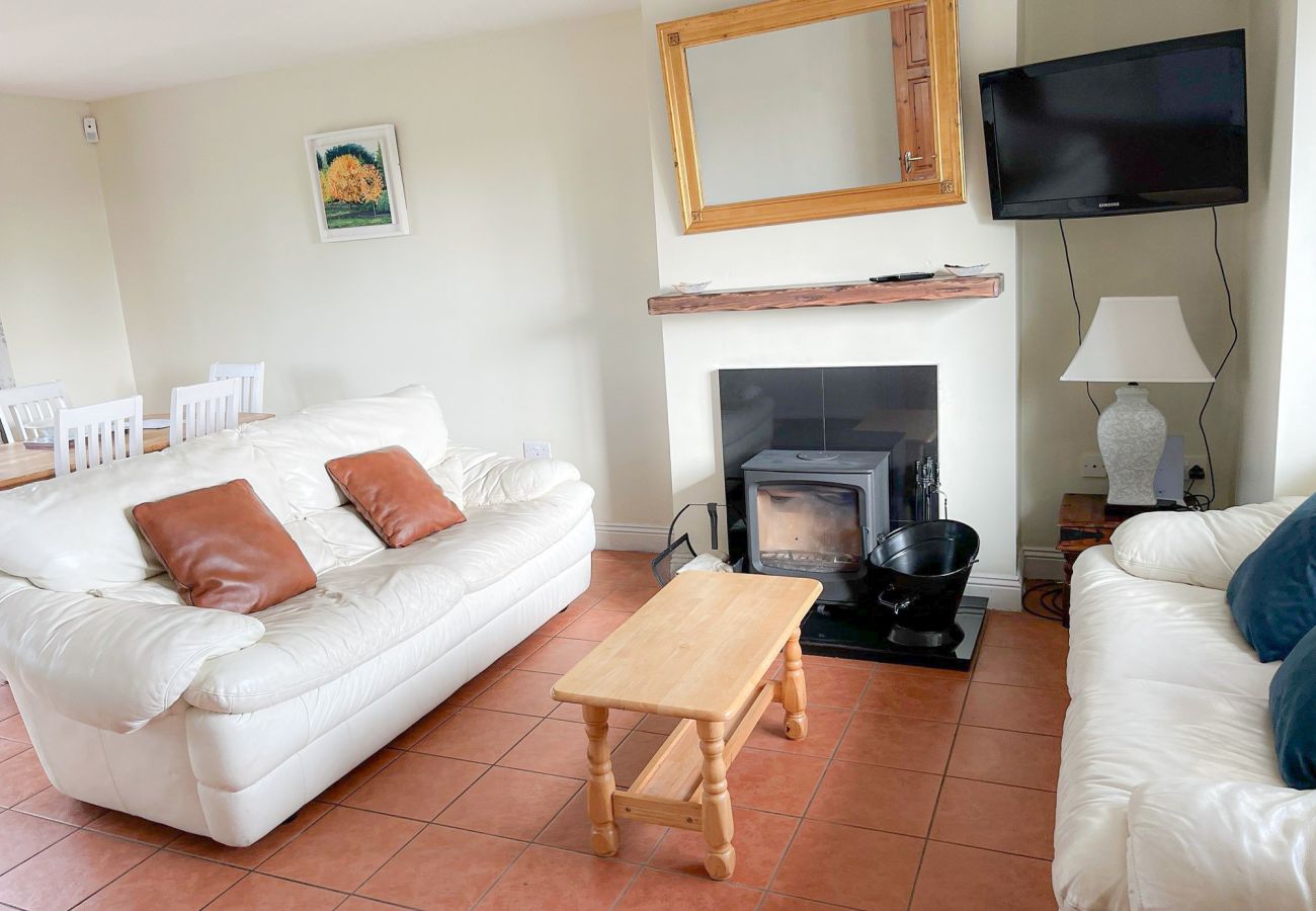 Seacliff Holiday Home No 43. Living room, rustic floors, bright patio window. 