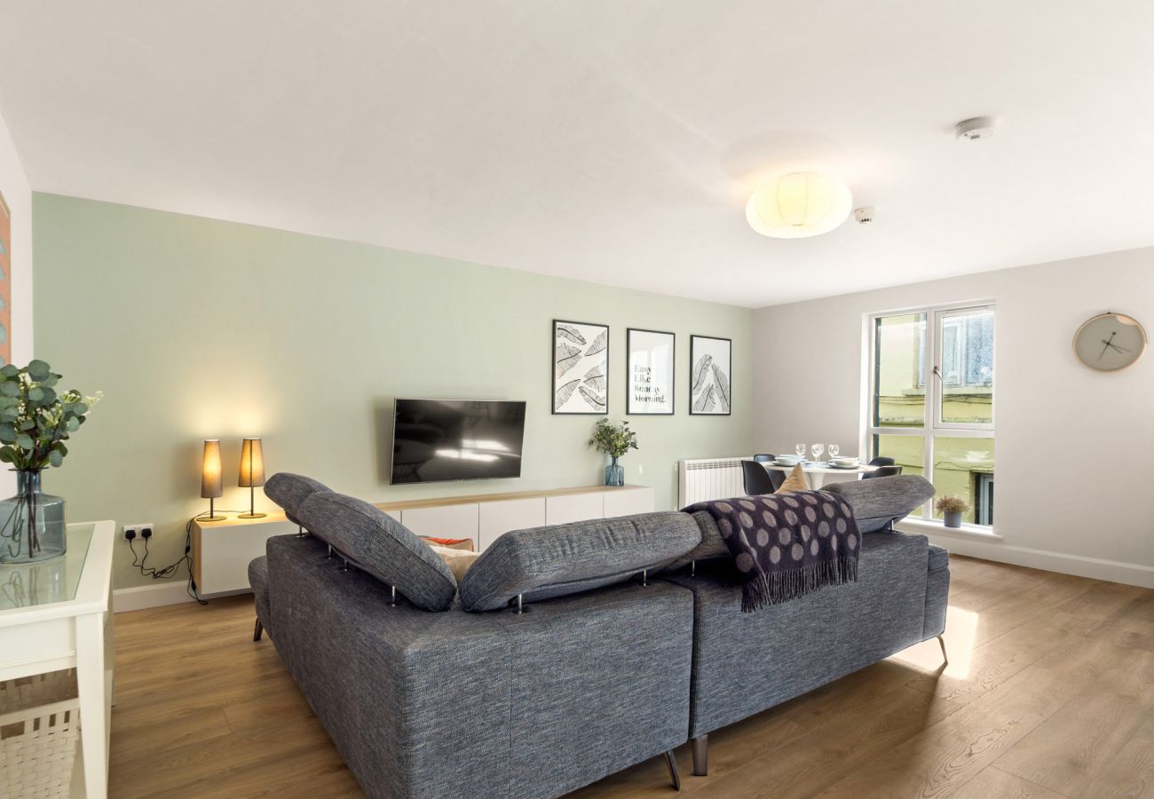 The Town Place Apartment Clifden. Living room open plan, modern. Large couch and smart TV