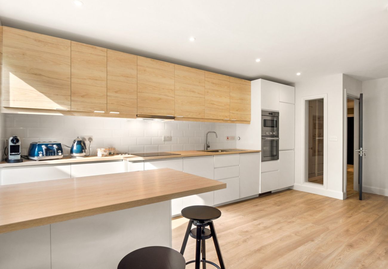 The Town Place Apartment Clifden.  Full service modern kitchen. Counter, wooden floors, clean bright. 