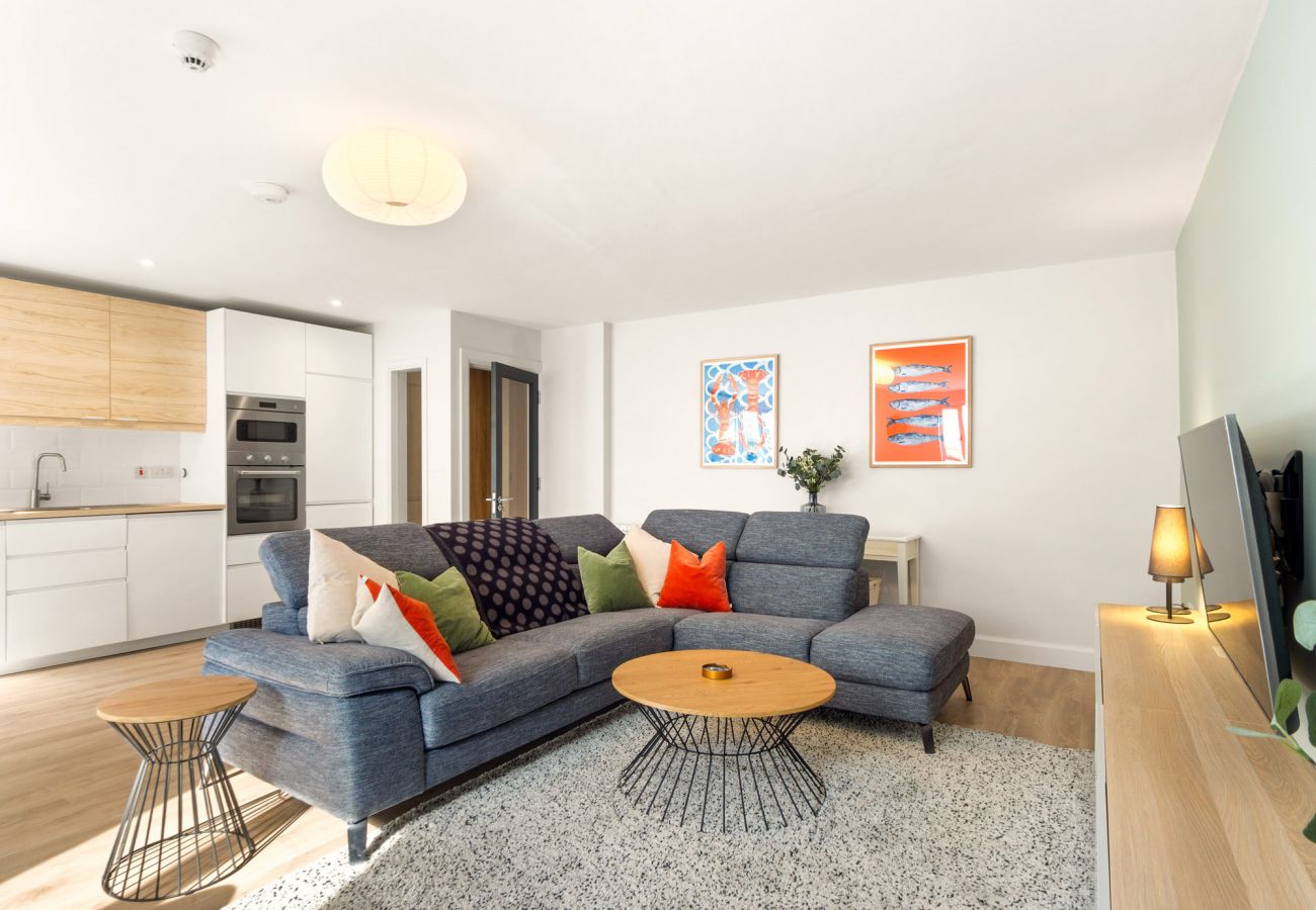 The Town Place Apartment Clifden. Living room open plan. L shaped couch, modern design smart TV