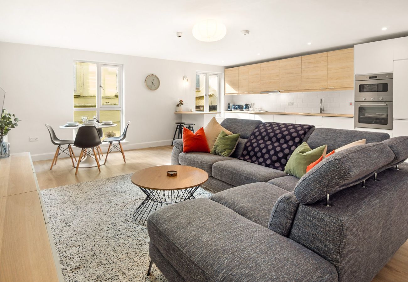 The Town Place Apartment Clifden. Living room open plan. Modern soft furnishing L shaped couch. Bright