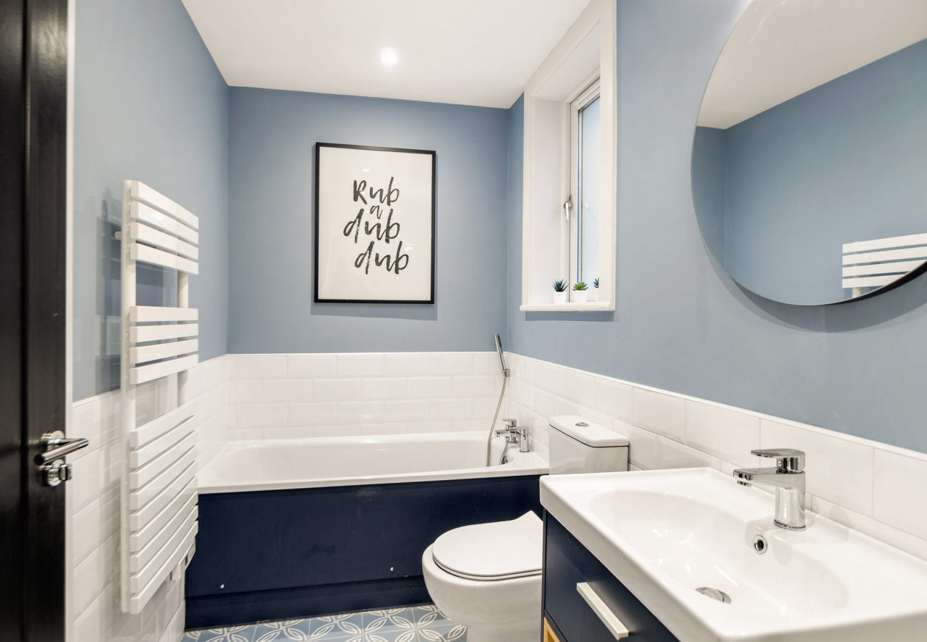 The Town Place Apartment Clifden. Modern bathroom. Sink and bath. 