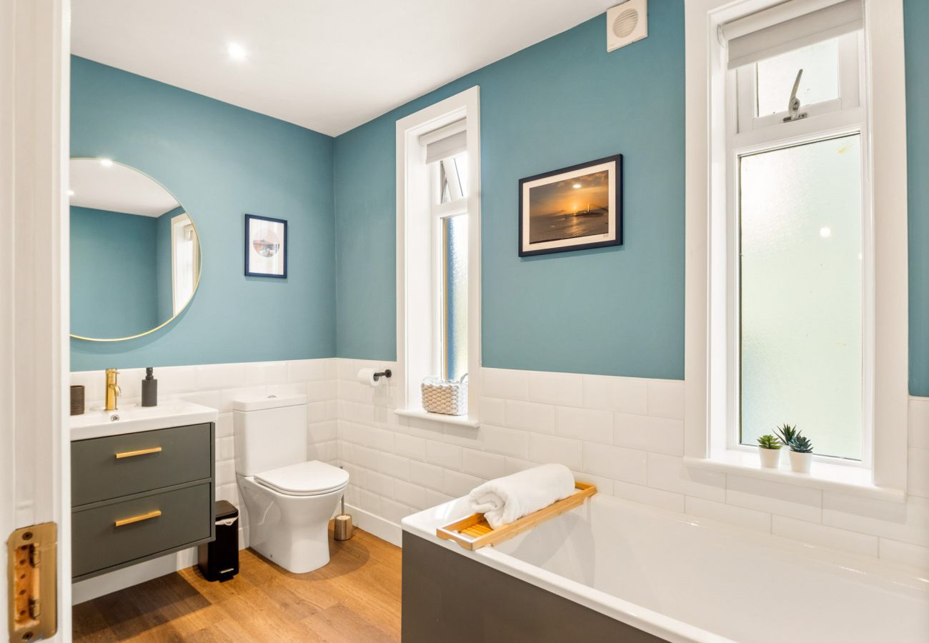 Clifden Boutique Apartment. Bathroom with bath, WC Sink. Modern tasteful high quality design