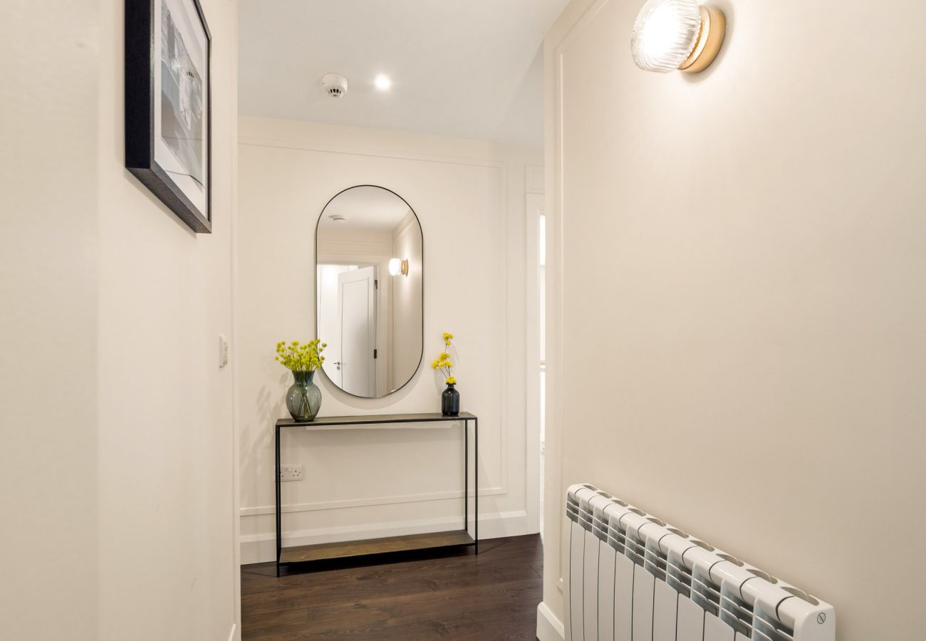 Clifden Boutique Apartment. Stylish hall with wooden floor