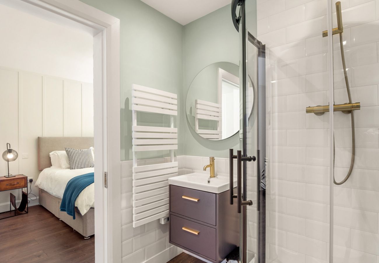 Clifden Boutique Apartment. En suite, walk in shower. Modern tiling. Sink. 