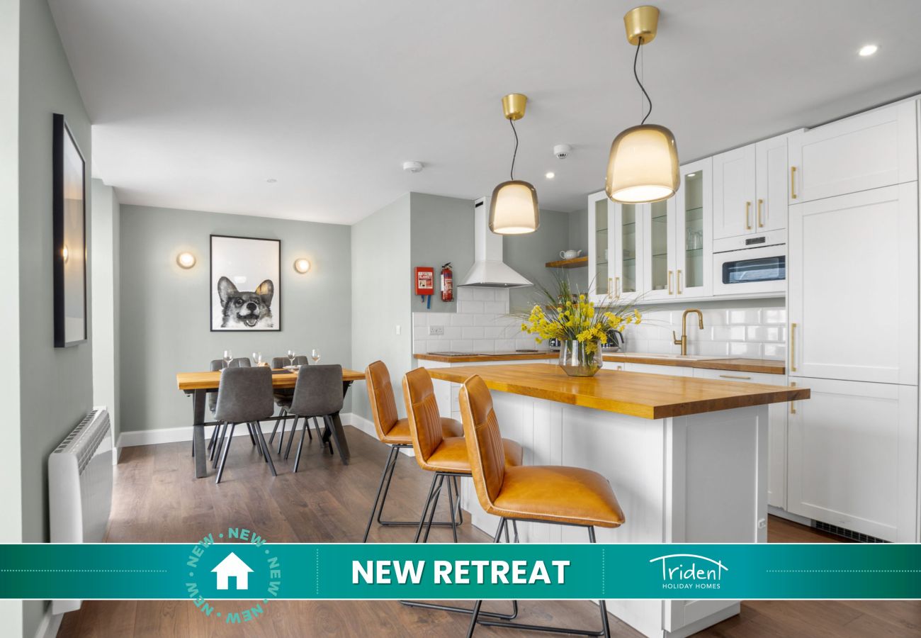 Clifden Boutique Apartment. Modern white kitchen, island wooden counter tops beautiful design.