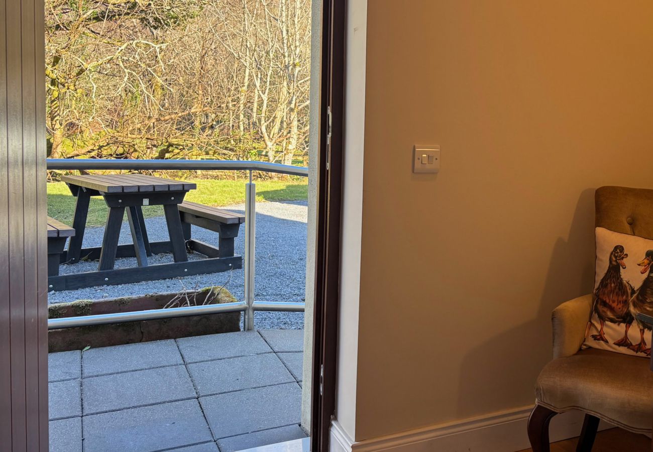 Kylemore Woodland Holiday Apartment. Exterior garden bench. 