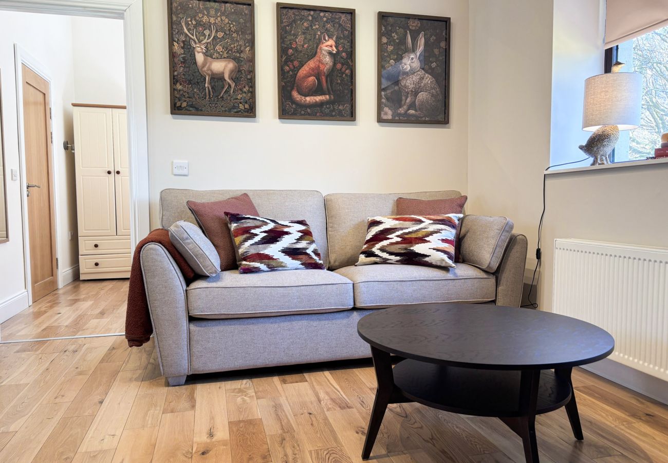 KylemoreWoodlandHolidayApartmentRef473. Loungeopen plan couch wooden floors