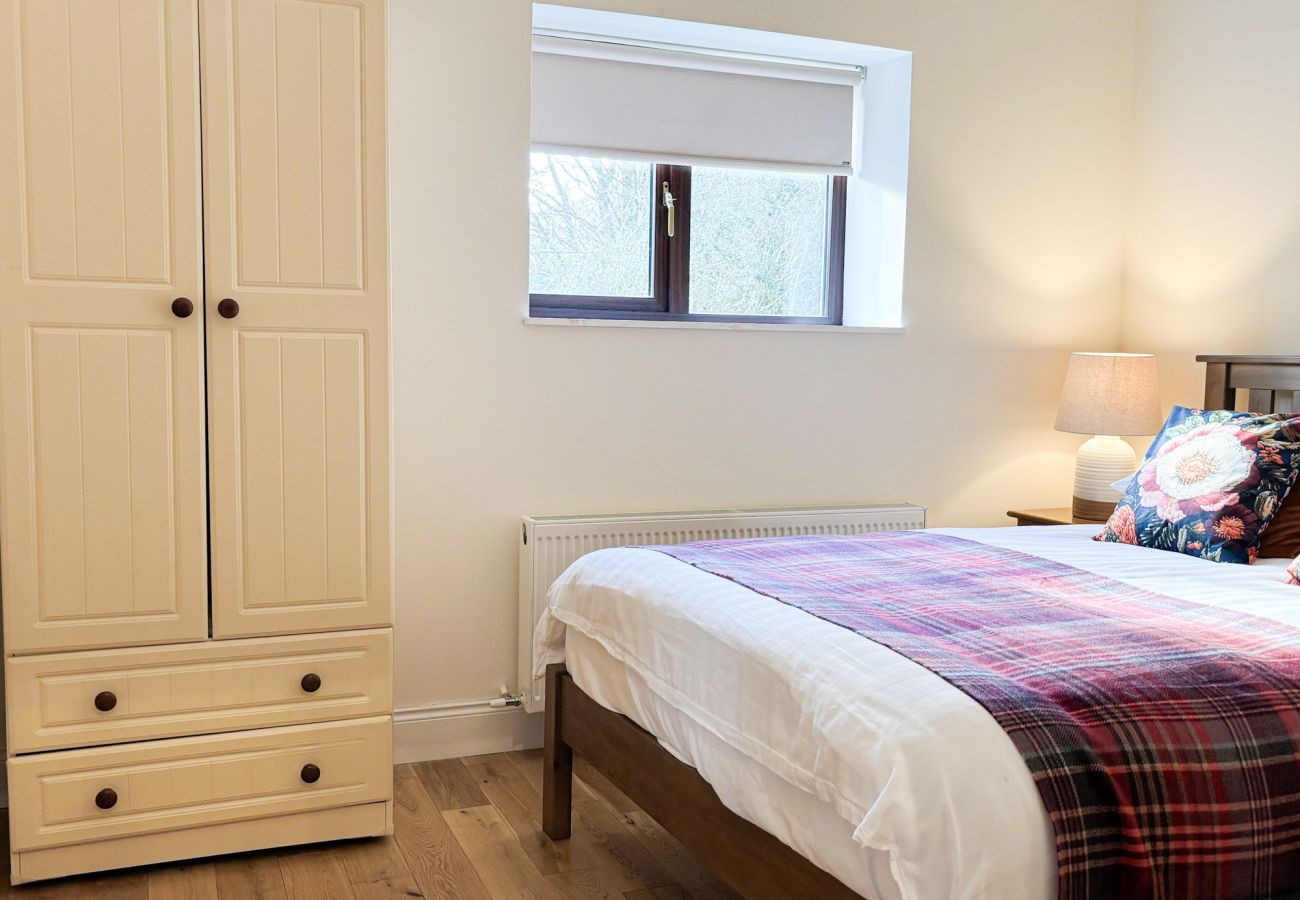 Kylemore Woodland Holiday Apartment. Double Bed side locker and desk