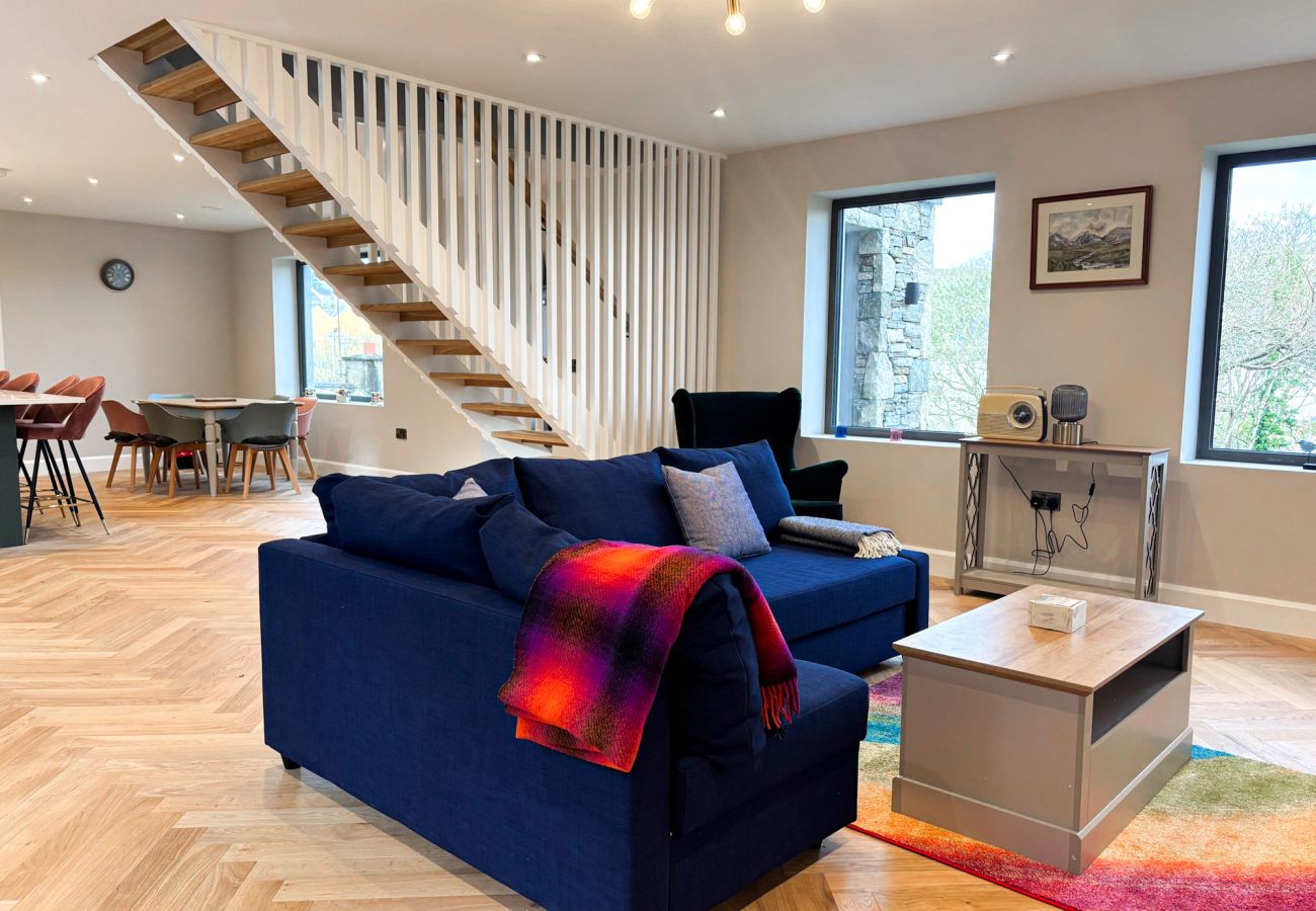 Clifden Holiday Home. Modern luxury home. open plan from kitchen to living room with staircase.