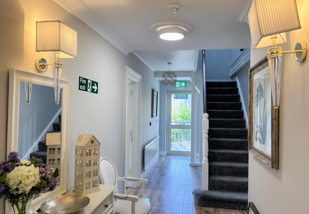 Luxurious Clifden Holiday Home. Bright hall, wooden floors, open stairs. 