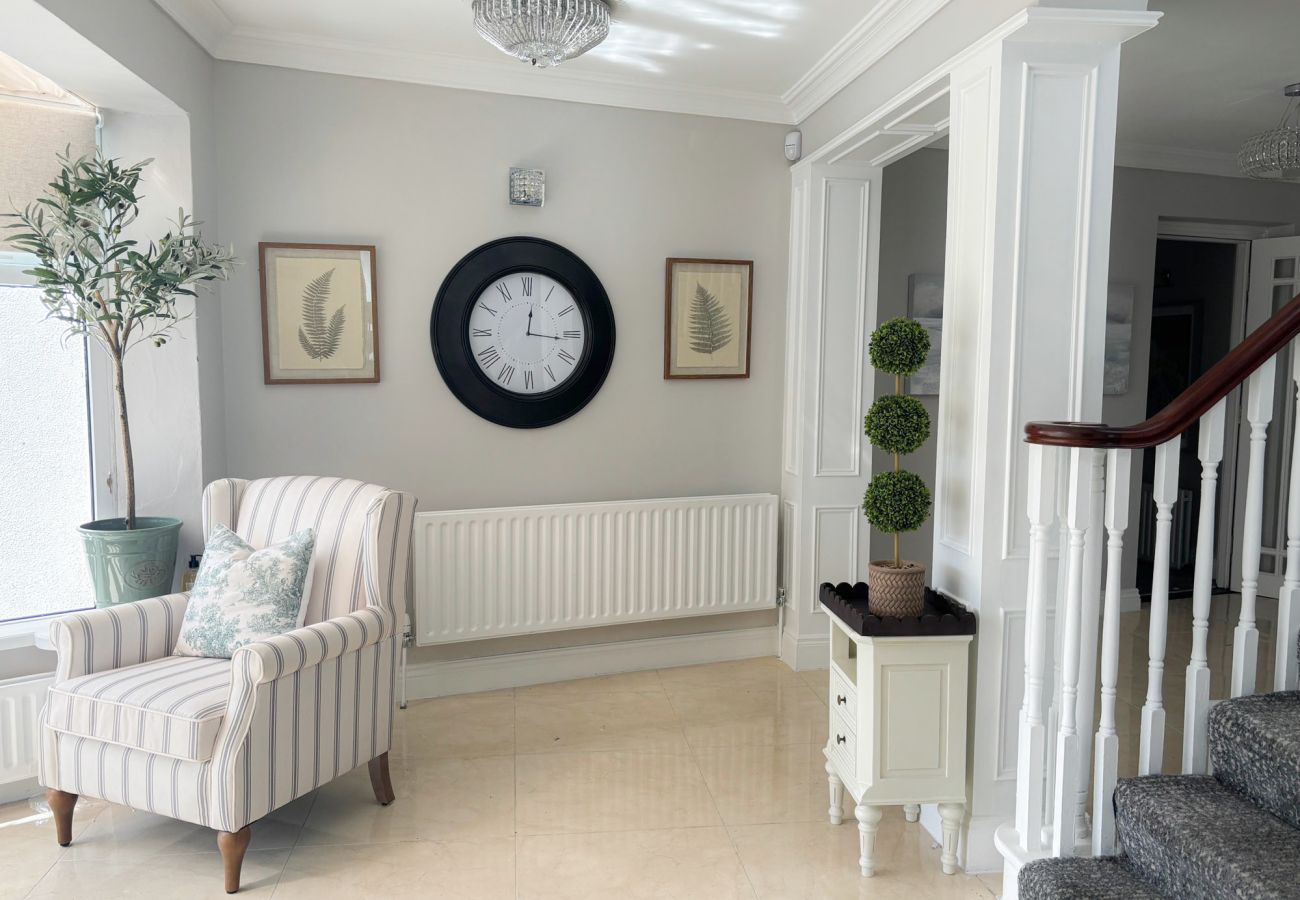 Luxurious Clifden Holiday Home. Large hall with seating and stairs. 