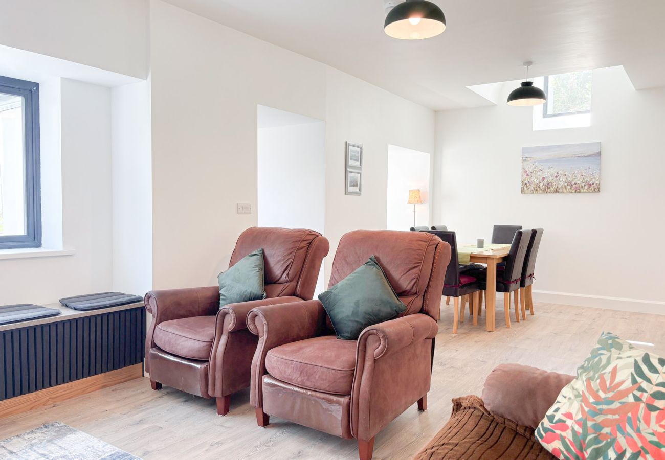 Bluebell Cottage Roundstone.  Living room suite open plan with large TV  dining table. 