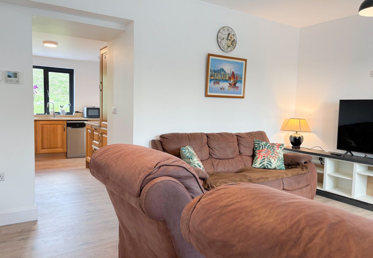 Bluebell Cottage Roundstone.  Living room, suite and TV comfortable. 