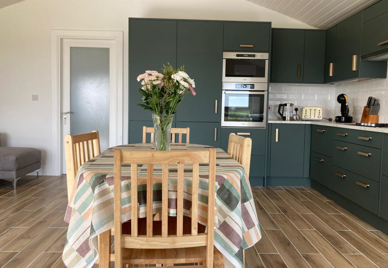 Claddaghduff Holiday Cabin. Diner kitchen. Dining table for 4 modern kitchen, wooden floors. 