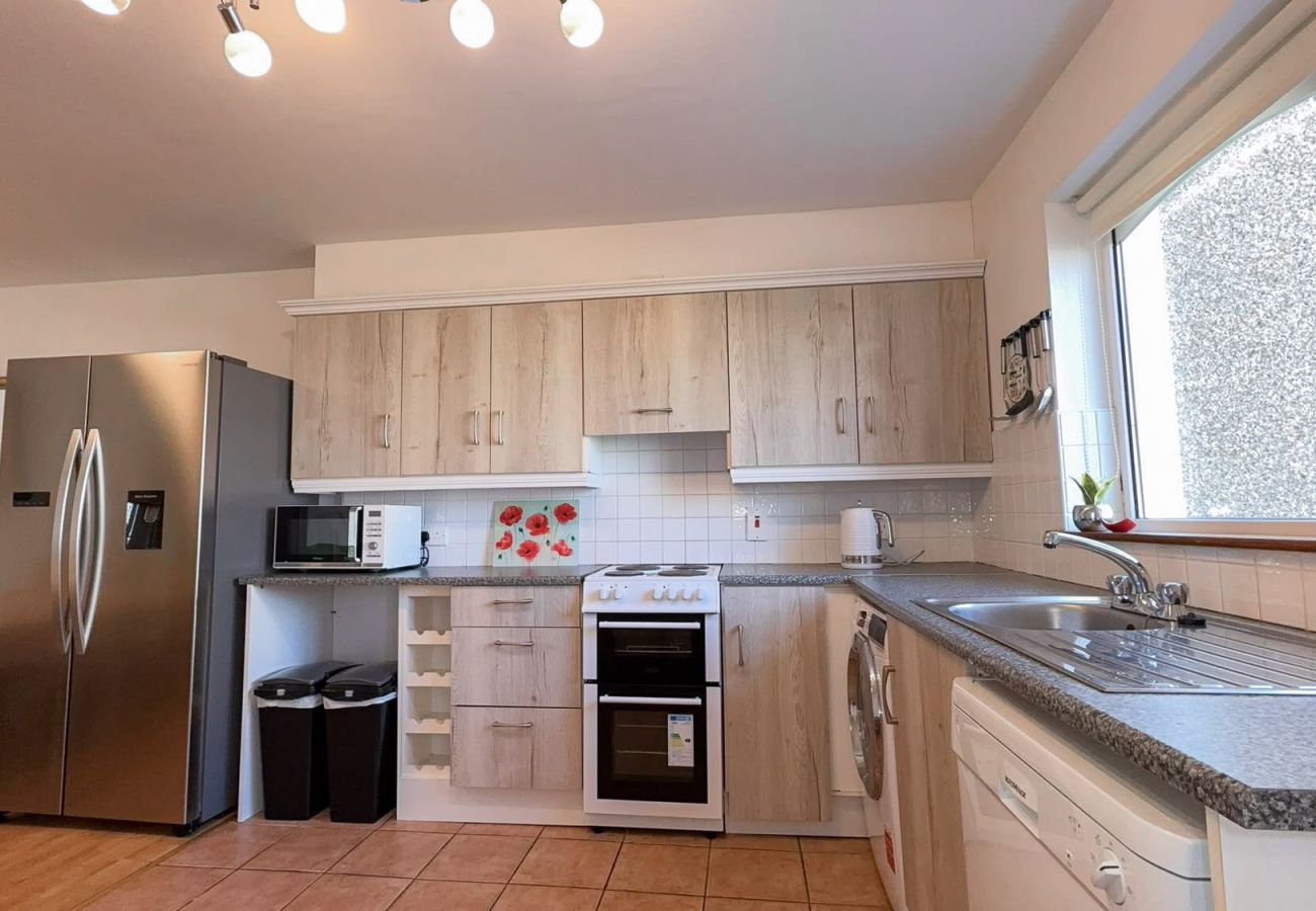 MooreBayHolidayVillage8D. Family holiday home Kilkee. Modern bright kitchen with american style large fridge. 