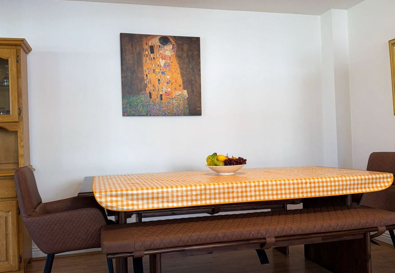 MooreBayHolidayVillage8D. Family holiday home Kilkee. Modern kitchen dining table, benches and chairs. 